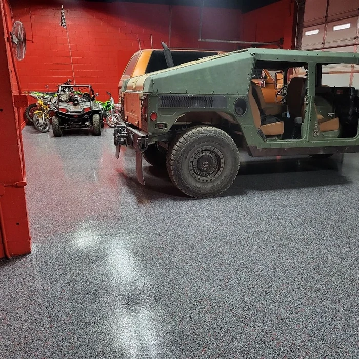 Gray flake garage floor with vehicles parked inside
