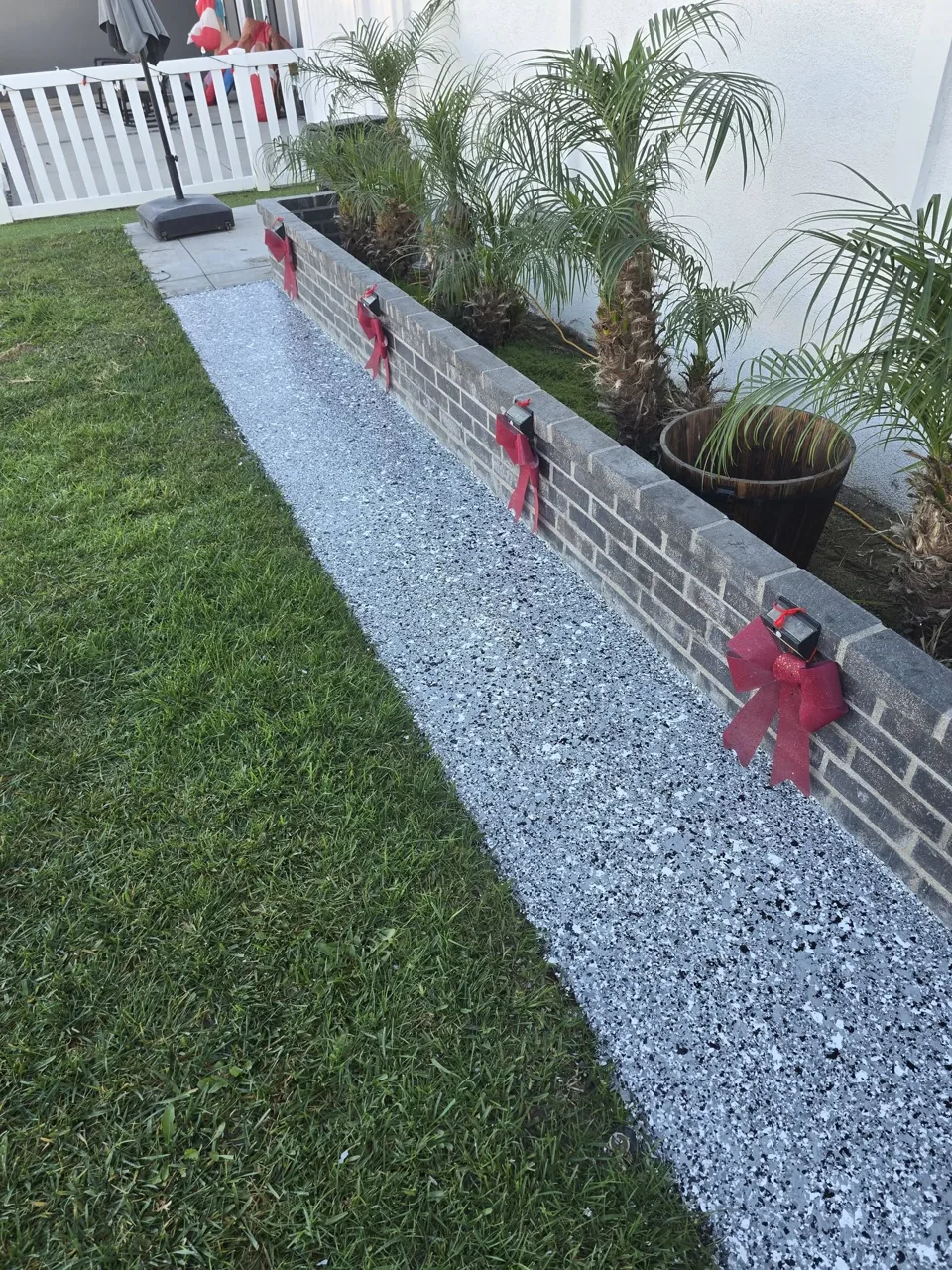 Flake-coated walkway beside a raised garden bed